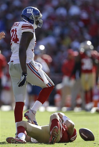Alex Smith down after getting sacked by Mathias Kiwanuka