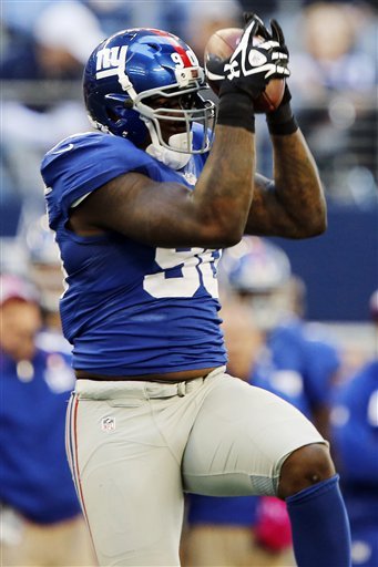 Jason Pierre Paul right after intercepting a pass from Tony Romo
